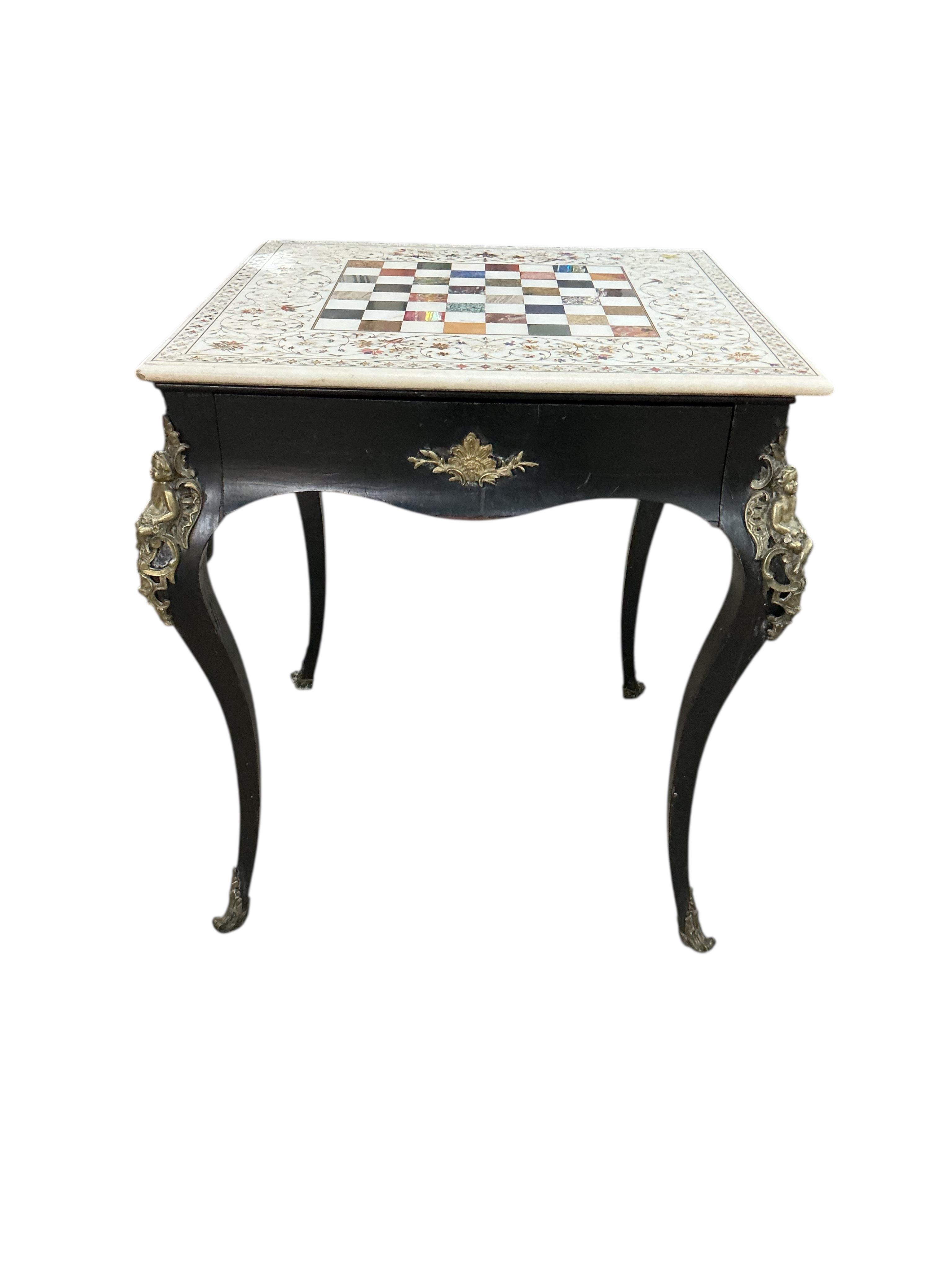 An Indian specimen marble chess set on an earlier associated gilt metal ebonised stand, width 68cm, height 74cm